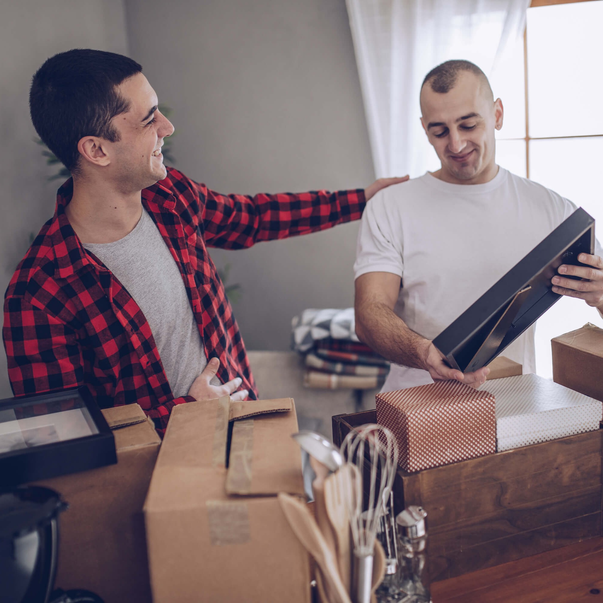 Couple opening packages - IQ Credit Union